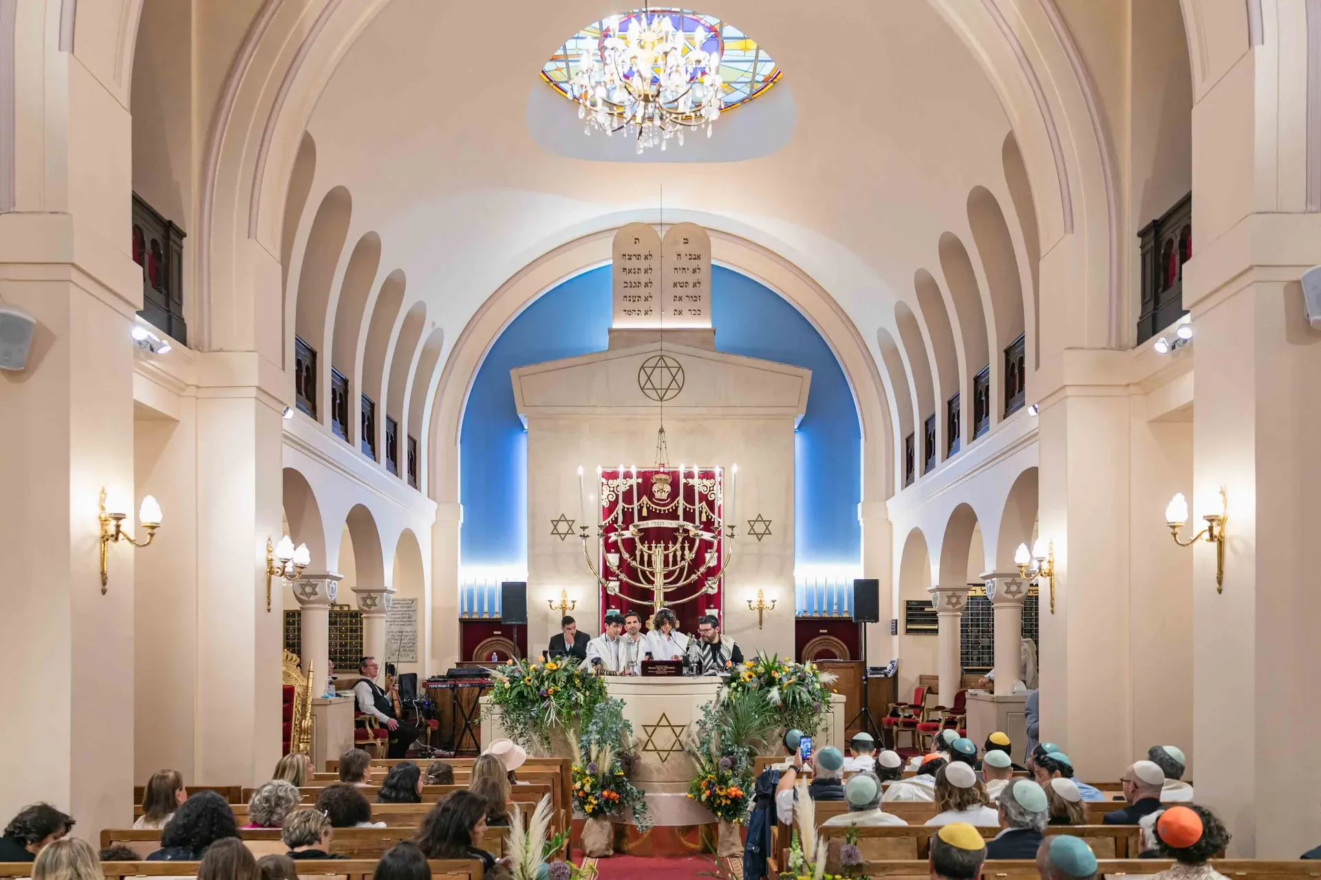 Vue d'ensemble de la synagogue parisienne pendant la cérémonie de Bar-Mitzvah, assemblée réunie sous les arcades